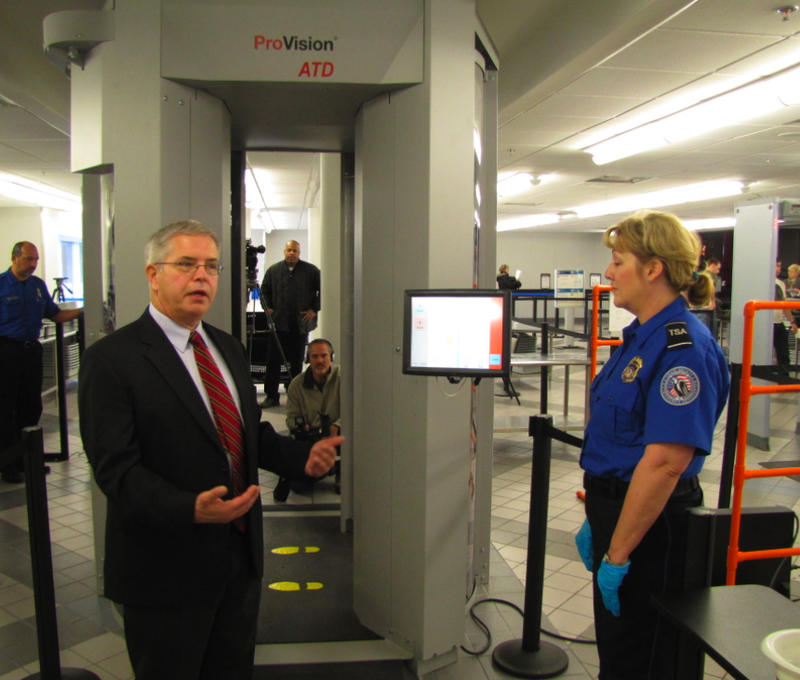 TSA Federal Security Director Jerry Henderson, left, talks about the new advanced imaging technology screening device behind him during a news conference Friday at Little Rock National Airport.