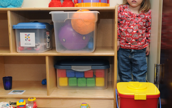 A 2-year-old girl hides in the corner of the infant playroom Nov. 30 at the Northwest Arkansas Children’s Shelter in Bentonville. Of the children brought to the shelter, about 70 percent are from cases of neglect, 20 percent from physical abuse, and 10 percent from sexual abuse. Katrina Lott, an employee of the shelter, says the greatest improvement she sees in the kids is how they relate to adults. This usually happens about three weeks after they arrive.