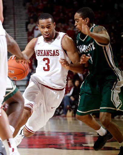 Arkansas Democrat-Gazette/JASON IVESTER -- 12/28/11 -- Arkansas sophomore Rickey Scott tries to get around Charlotte senior Derrio Green during the first half on Wednesday, Dec. 28, 2011, at Bud Walton Arena in Fayetteville.