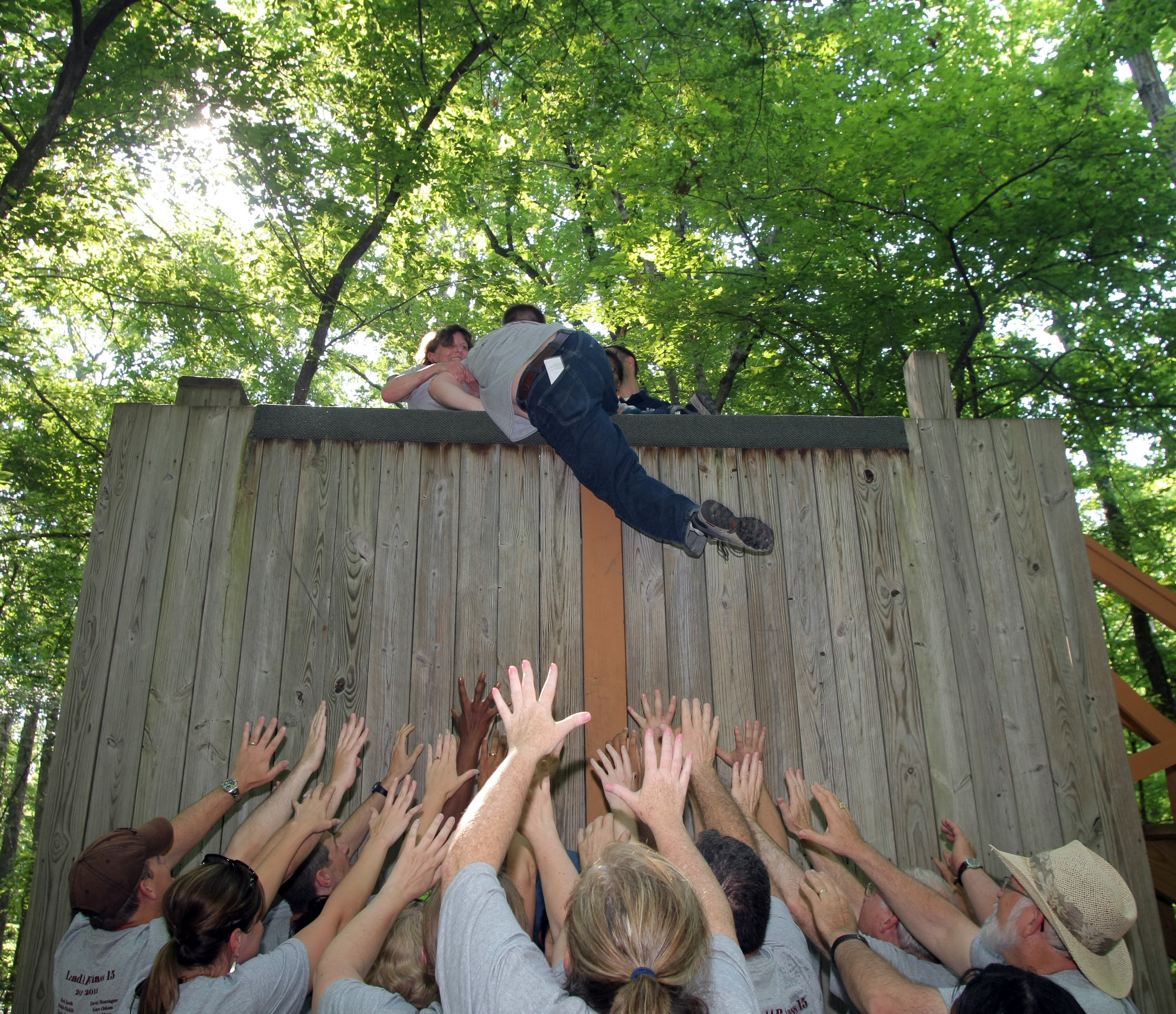Arkansas Democrat-Gazette/JOHN SYKES JR. - 6/2/11 -  Members of LeadAR class 15 participate in ExCEL, a University of Arkansas Division of Agriculture experiential-based training and development program. Class members work together to get a teammate over a wall. Chris Wilson of Little Rock gets pulled over after a big boost from his team.