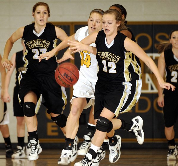 Taylor Lee of Bentonville, right, chases down a loose ball Thursday.
