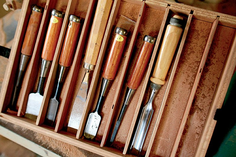 Lewis Neidhardt uses wood chisels to make wooden products in his shop at his home in Sherwood. 