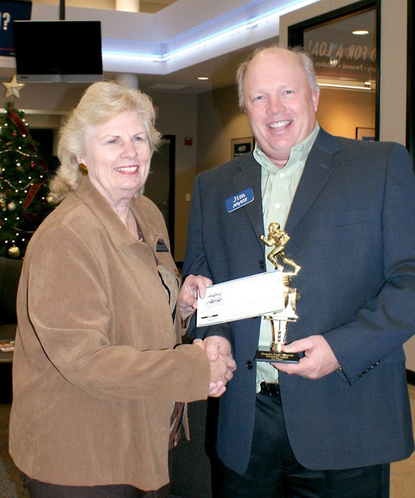 Sherry DuBois presents check to Jim Singleton.