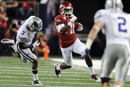 Arkansas' Cobi Hamilton (11) runs against Kansas State's Allen Chapman (3) as Tysyn Hartman (2) defends during the first half of the Cotton Bowl in Arlington, Texas.