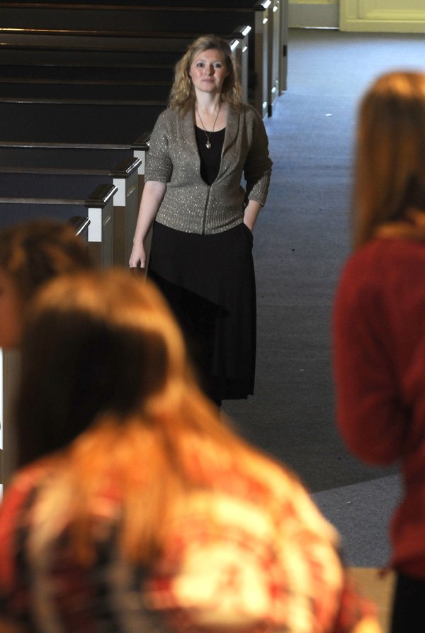 Virginia Scheuer, drama teacher at Benton County School of the Arts, watches her students Friday perform as Italian comedy characters the class is studying. The school has adopted a policy changing how teachers’ contracts are handled.
