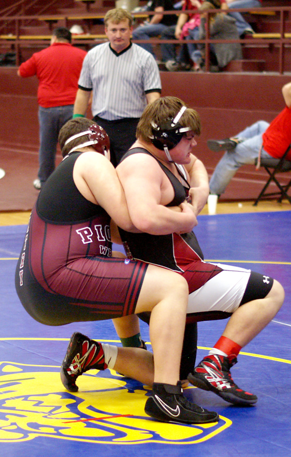 Freshman Zach Ellis takes down his opponent in the match for third place in the heavy-weight division on Saturday.