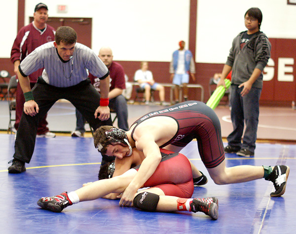 Gentry freshman Cody Watson works to turn his opponent Saturday. Watson later obtained the fall.