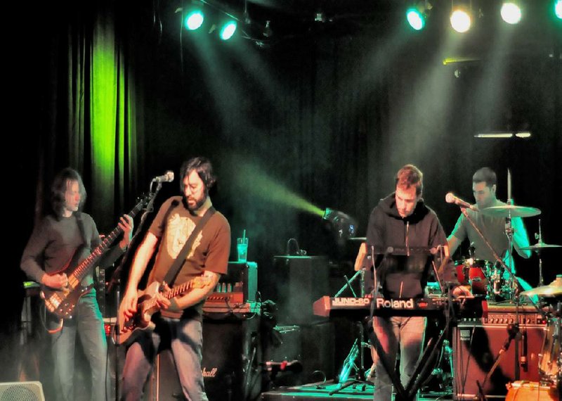 Little Rock band Year of the Tiger — Andrue Sullivan (from left) Mike Mullins, Jeremy Brasher and Josh Tate — at a recent gig. The CD release show for the group’s debut EP Midnight Hands is Saturday at Stickyz Rock ’N’ Roll Chicken Shack. 