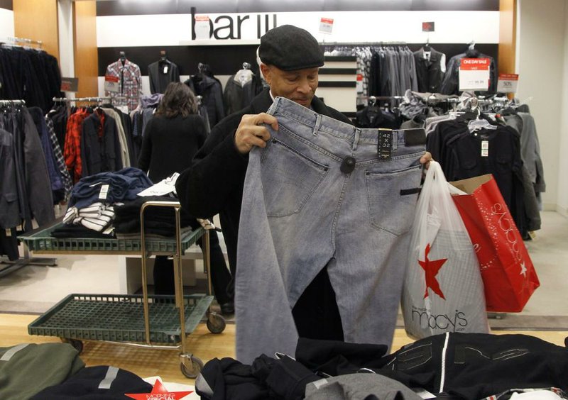 Jerry Clay of Chicago shops at the Macy’s store on State Street in Chicago on Dec. 13. A monthly survey shows consumers’ confidence in the economy in December surged to the highest level since April and is near a post-recession peak.