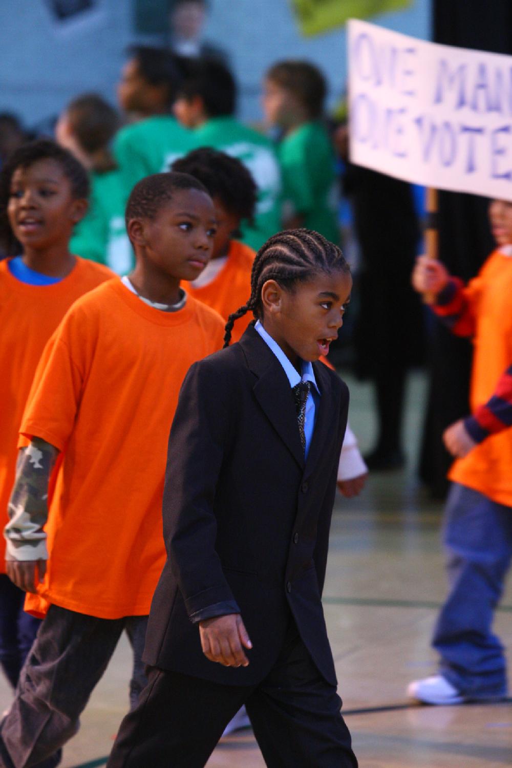 Arkansas Democrat-Gazette/STEPHEN B. THORNTON --1-13-12--
Layden Breedlove, 9, sings and marches at the front of a civil rights march as he plays Dr. Martin Luther King Jr. during a presentation celebrating of Dr. King's life and work Friday afternoon at Booker Arts Magnet Elementary School in Little Rock. The musical play artin Luther King, Jr. The Story of a Dream