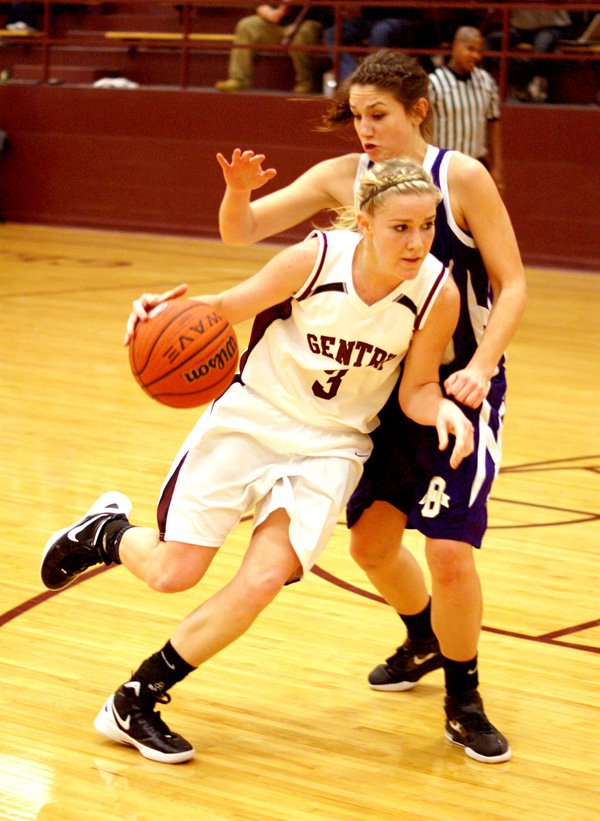 Gentry junior Tara Arnold dribbles around an Ozark player during the Jan. 10 homegame in the Pioneer gymnasium.
