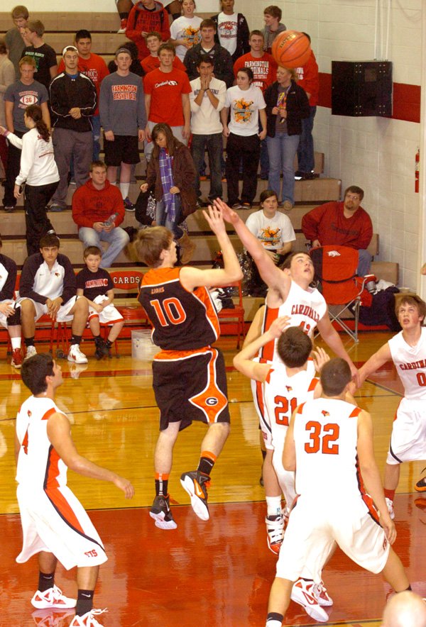 Terence Pierce of Gravette dribbled into the lane to get off a high-percentage shot over four Farmington defenders. The Gravette senior boys basketball team won a conference game, 62-45, at Farmington on Jan. 10.
