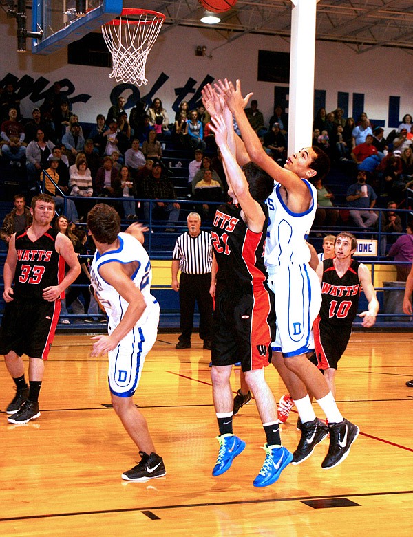 Decatur junior Andrew Harris stretched for a rebound during Friday’s game against Watts.
