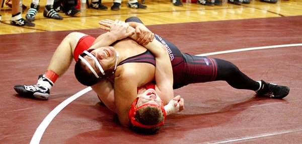 Gentry senior Ricky Hernandez works to pin his Northside High School opponent on Thursday in Gentry's Carl Gym. Hernandez won the match and Gentry picked up a team win.
