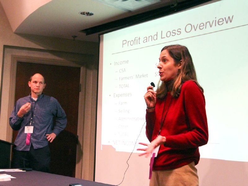 Emily Oakley, accompanied by Mike Appel, speaks about their farm’s finances during a seminar at the Southern Sustainable Agriculture Working Group conference in Little Rock. 