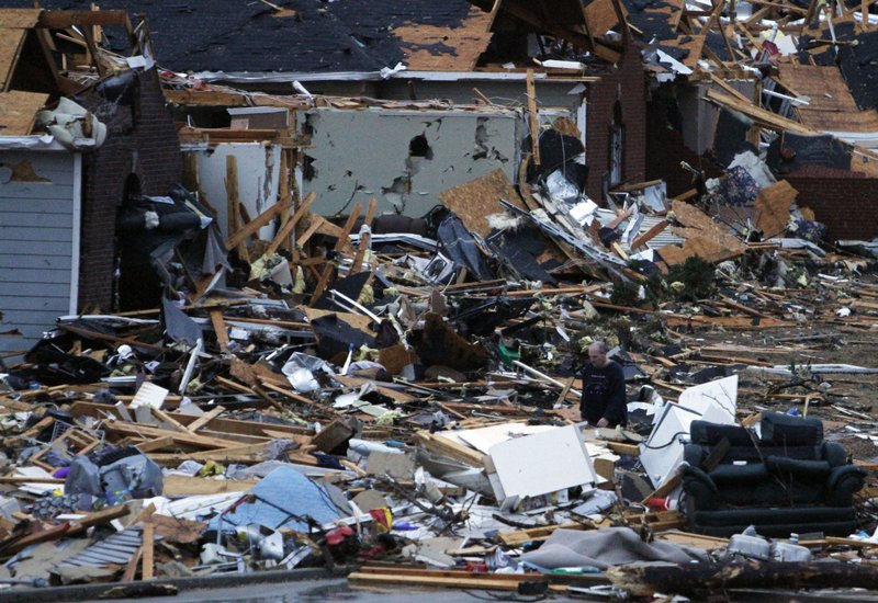 Residents walk around through the debris of their neighborhood after a possible tornado ripped through the Trussville, Ala. area in the early hours of Monday, Jan. 23, 2012. Jefferson County sheriff's spokesman Randy Christian said the storm produced a possible tornado that moved across northern Jefferson County around 3:30 a.m., causing damage in Oak Grove, Graysville, Fultondale, Center Point, Clay and Trussville. 