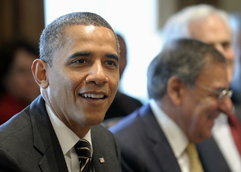President Barack Obama, sitting next to Defense Secretary Leon Panetta, speaks Tuesday during a Cabinet meeting in the White House in Washington. 