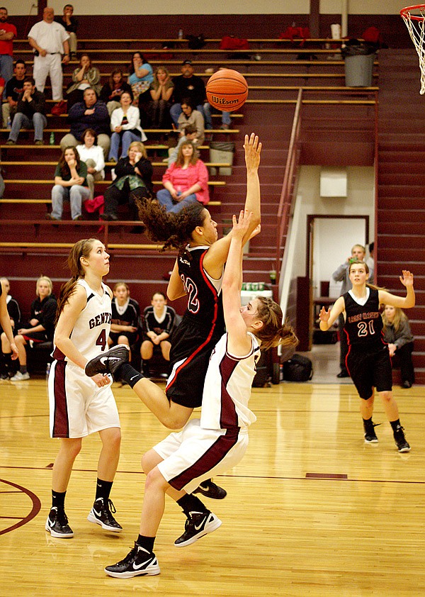 Pea Ridge player Savannah Cypert charges Destiny Thomas in a layup attempt, while Shelby Hammond looks on, during play between the Lady Pioneers and the Lady Blackhawks on Jan. 24 in Gentry.