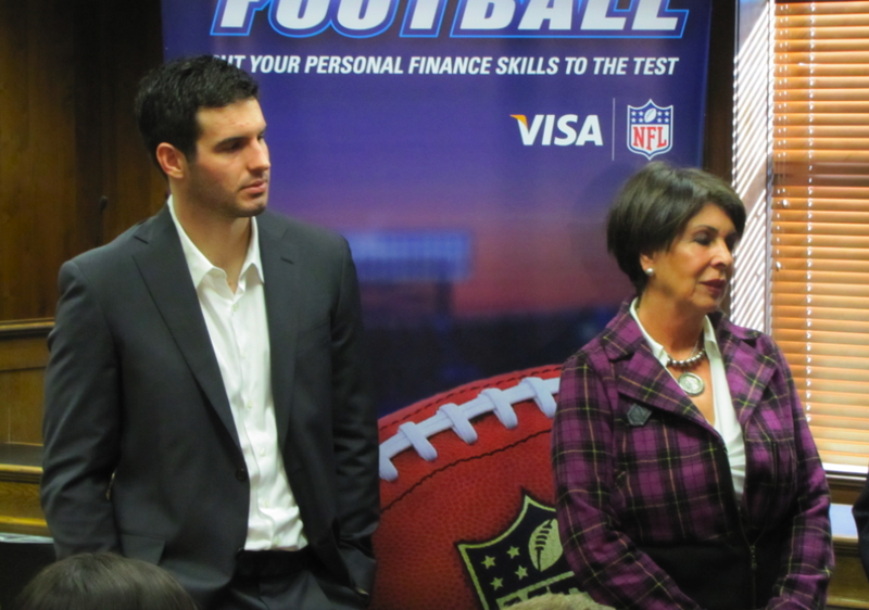 Minnesota Vikings quarterback Christian Ponder and Arkansas Treasurer Martha Shoffner participate in a news conference and demonstration Thursday on "Financial Football," a video game that teaches money management lessons.