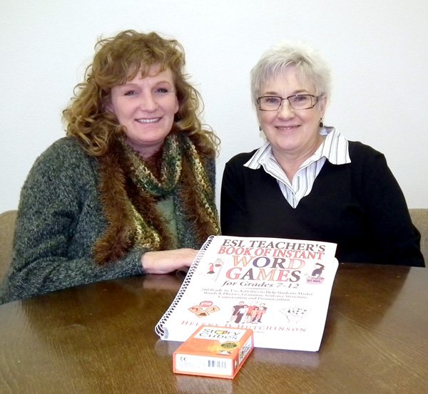 Chris Nelson, a volunteer tutor for the Community Literacy Program of Decatur, and Boni Vrieze, coordinator of the program, show some of the program’s teaching materials.