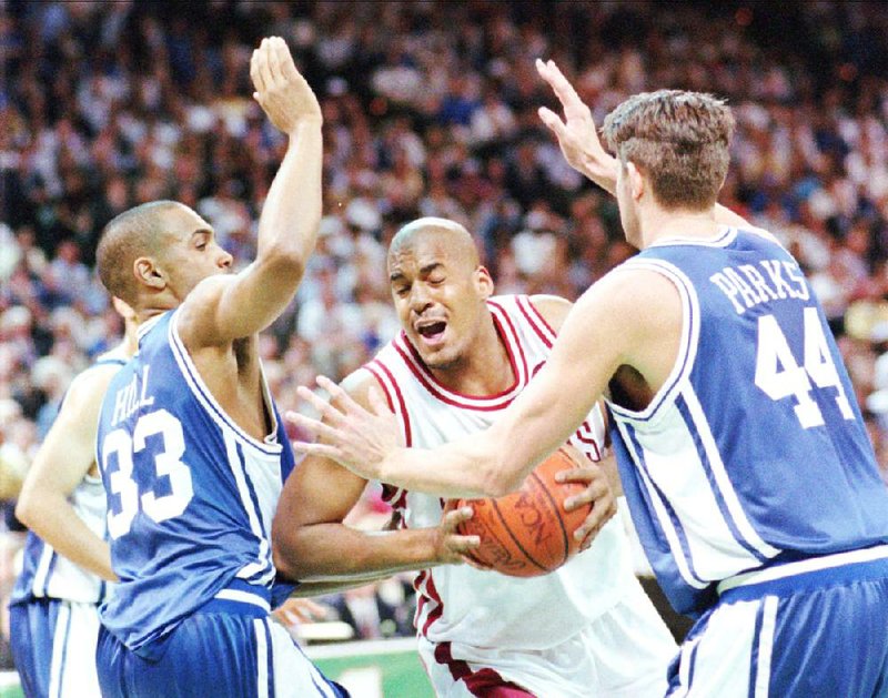 Arkansas’ Corliss Williamson (center) drives between Duke’s Grant Hill (left) and Cherokee Parks during the 1994 NCAA championship game in Charlotte, N.C. “We had a team full of guys who accepted their roles and played those roles to their best of their ability,” Williamson said. 