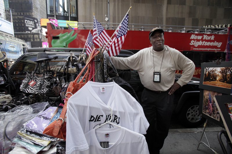 In an April 27, 2011 file photo, Duane Jackson, one of the first people to alert police officers to a suspicious vehicle that contained a crude bomb in New York's Times Square in May 2010, works at his stand. Jackson, 59, said Tuesday, Feb. 7, 2012 that he is seeking the Democratic nomination to challenge Republican Congresswoman Nan Hayworth in his home district north of New York City.