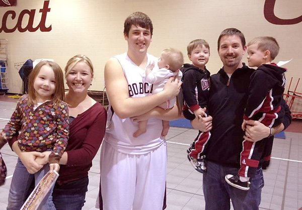 Gentry Coach Nick Bartmier, his wife Sarah and their children visit with former Gentry student Kevin Scherer when they traveled to watch him play at a College of the Ozarks .