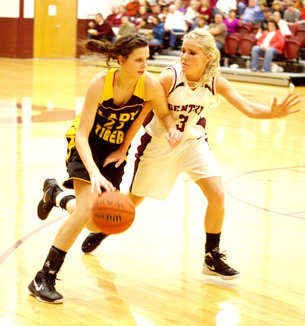 Gentry's Tara Arnold (right) guards against Prairie Grove's Justyne Huber during play in Gentry on Friday night, following colors day ceremonies.