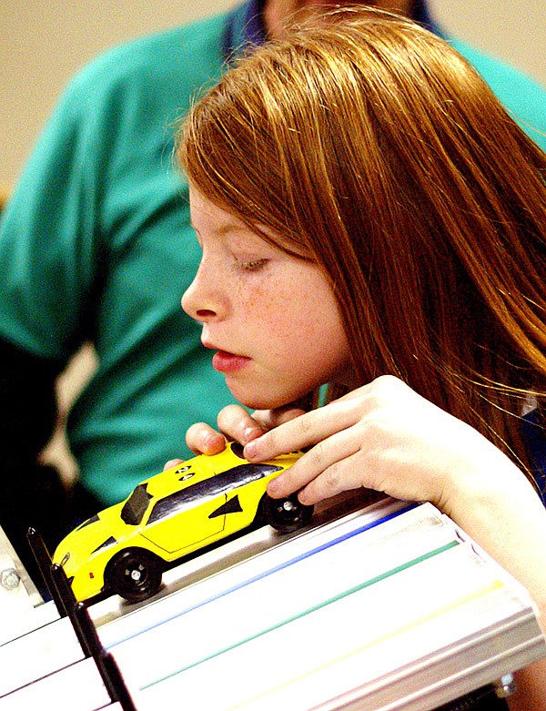 Autumn Baker carefully places her car on the track to race it in the AWANA Grand Prix held at Gentry First Baptist Church on Feb.1.