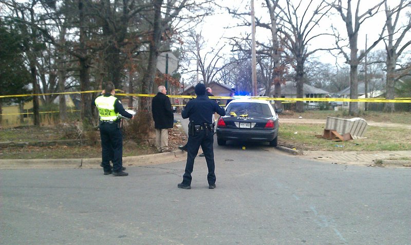 Police investigate the scene of a Little Rock shooting Wednesday at West 19th and South Brown Streets. 