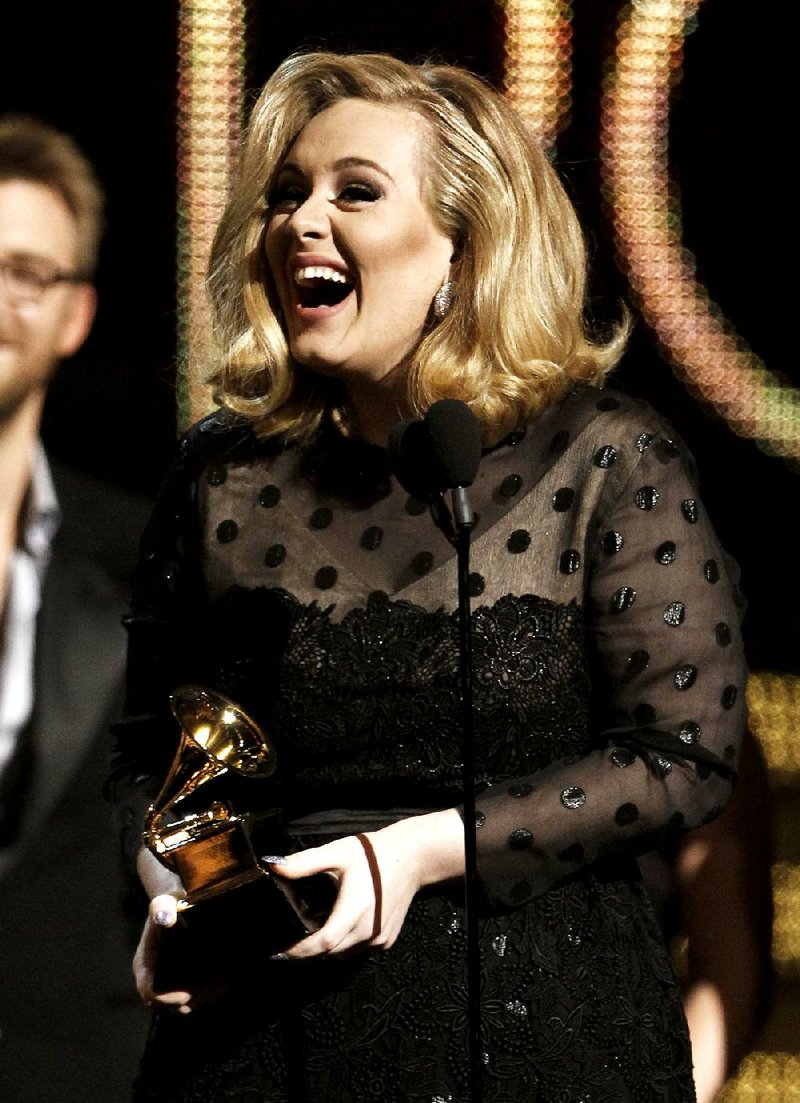Adele accepts the award for record of the year for Rolling in the Deep during the 54th annual Grammy Awards on Sunday in Los Angeles. 