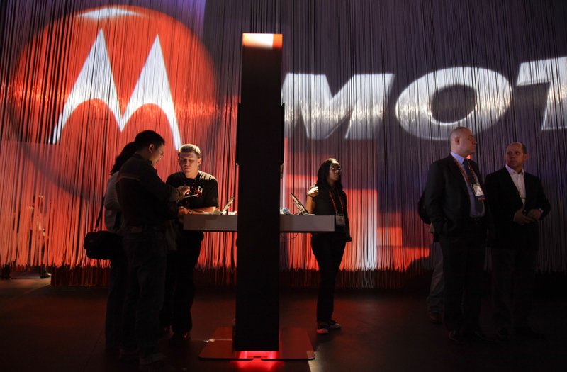 In this Jan. 10, 2012 file photo, industry affiliates examine various apps on Motorola tablets during the 2012 International CES tradeshow, in Las Vegas. The EU's antitrust watchdog has approved Google's $12.5 billion takeover of cell phone maker Motorola.