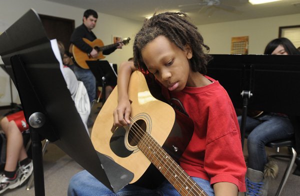 Kristofer Bland, 11, plays scales on the guitar Friday at the Benton County School of the Arts in Rogers. The school’s board voted Tuesday to seek accreditation through AdvancED. Administrators will attend training in March and a visiting team will tour the high school and kindergarten through eighth-grade campus in April.