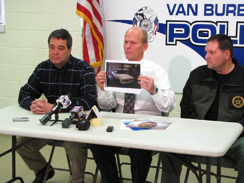 Van Buren Police Chief Kenneth Bell, center, holds up a picture of a pickup belonging to Lloyd Jones of Lavaca, a registered sex offender who was arrested Thursday in the disappearance of  16-year-old Angela Allen.