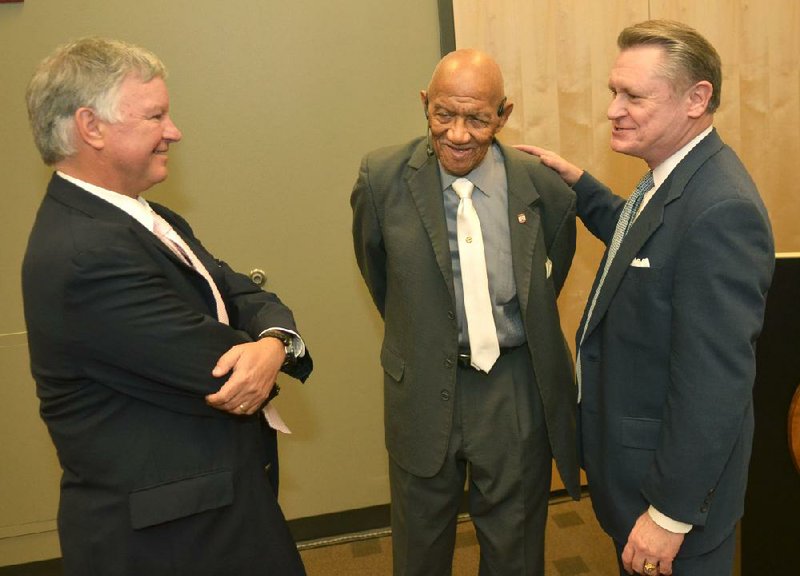 Brad Choate, vice chancellor for university advancement, (left) and University of Arkansas Chancellor G. David Gearhart (right) talk Monday with Christopher C. Mercer, a recipient of one of the Silas Hunt Legacy Awards to be presented by the university this spring.