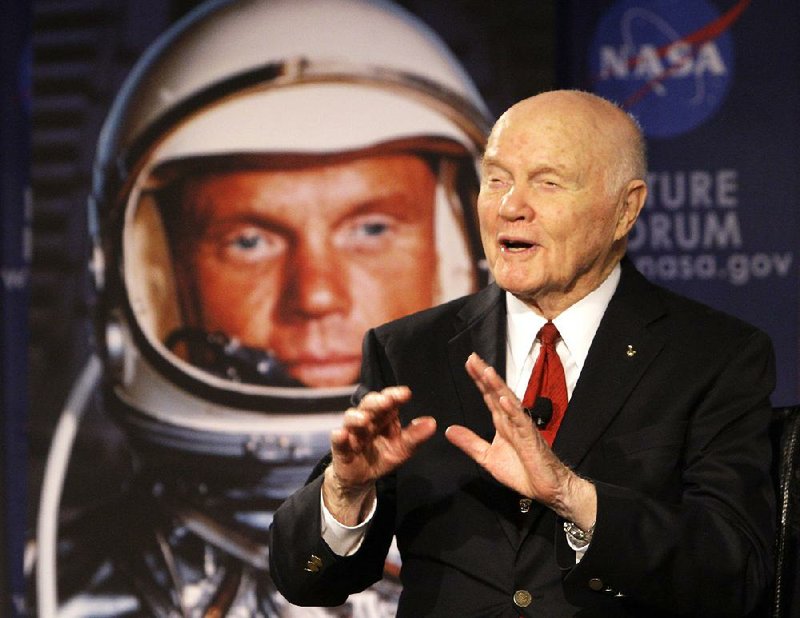 Sen. John Glenn talks, via satellite, with the astronauts on the International Space Station, before the start of a roundtable discussion titled "Learning from the Past to Innovate for the Future" Monday, Feb. 20, 2012, in Columbus, Ohio. Glenn was the first American to orbit Earth, piloting Friendship 7 around it three times in 1962, and also became the oldest person in space, at age 77, by orbiting Earth with six astronauts aboard shuttle Discovery in 1998. (AP Photo/Jay LaPrete)