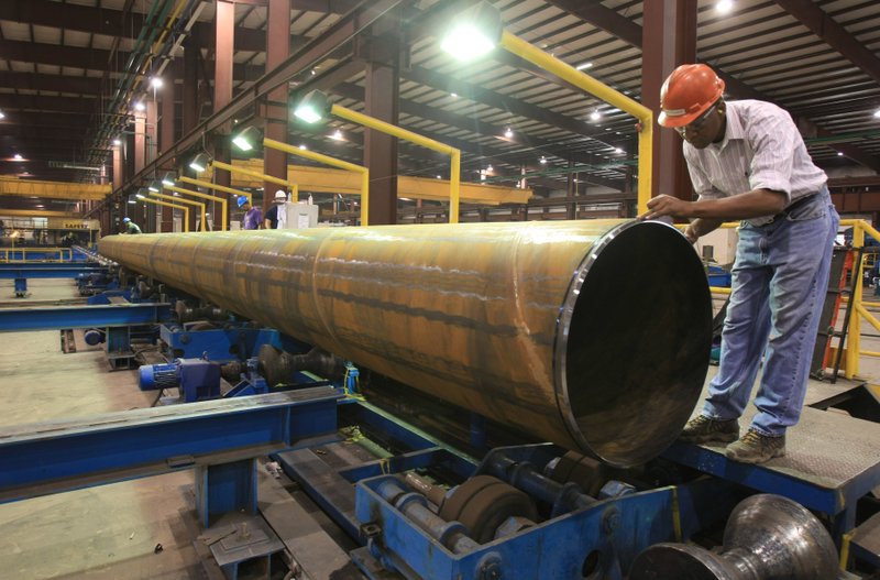 Joseph King measures the circumference of a pipe at the Little Rock Welspun facility in Little Rock.