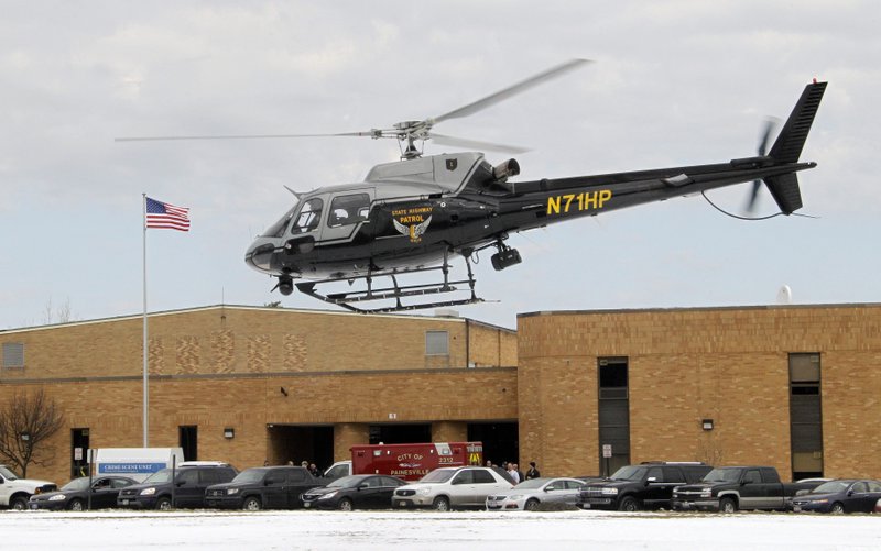 An Ohio Highway Patrol helicopter takes off from the rear of Chardon High School in Chardon, Ohio Monday, Feb. 27, 2012. A gunman opened fire inside the high school's cafeteria at the start of the school day Monday, wounding five students, officials said. Special Agent Vicki Anderson said Monday the shooter was taken into custody near his car about half a mile away from the high school. A spokesman for the Cleveland Clinic confirmed five students were being treated at two different hospitals. 