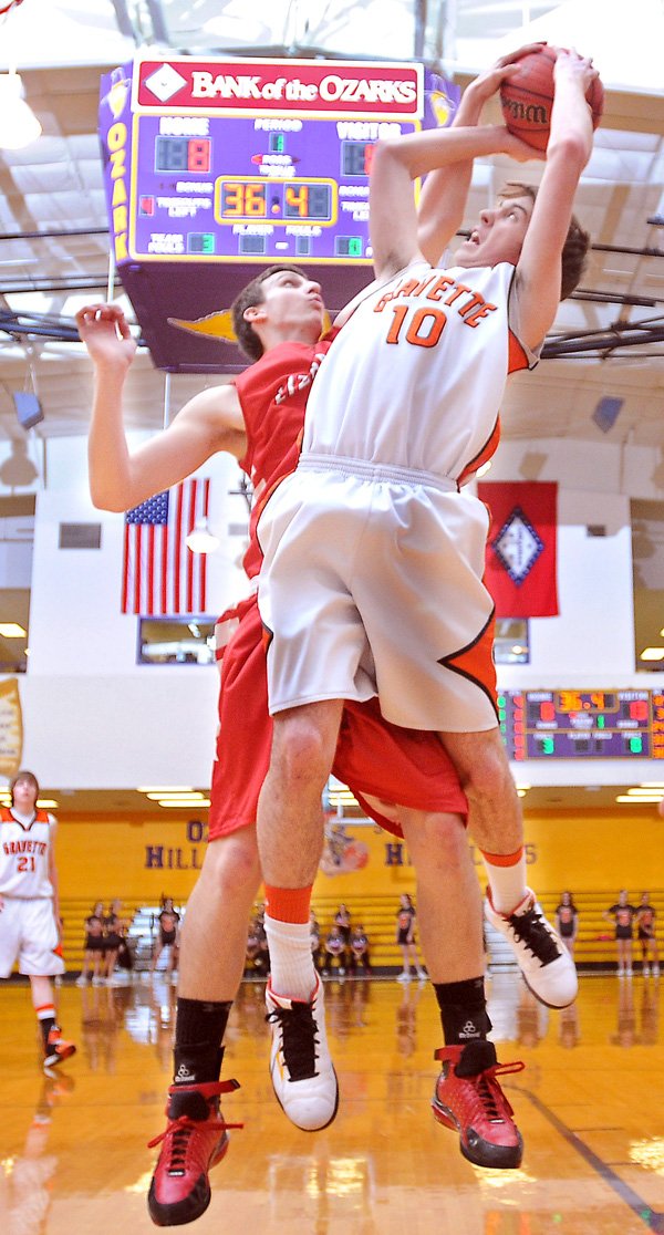 Mark Gathright of Dardanelle High School attempted to block a shot by Gravette High School's Terence Pierce in play against Ozark High School in Ozark on Feb. 22. The Lions of Gravette beat the Dardanelle Lizards in overtime, 62-61.