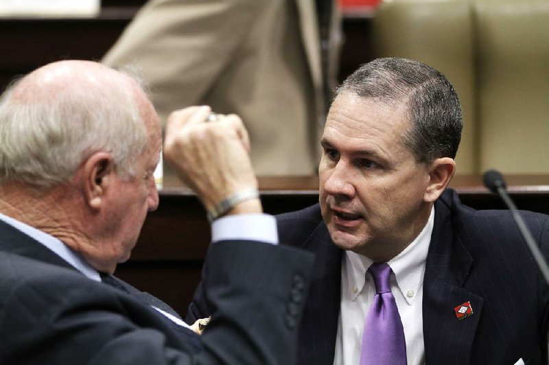 Senate President Pro Tempore Paul Bookout (right) speaks with Sen. Kim Hendren during budget talks Tuesday. Bookout said nobody in the Senate had budged on the trucker sales-tax exemption repeal. 
