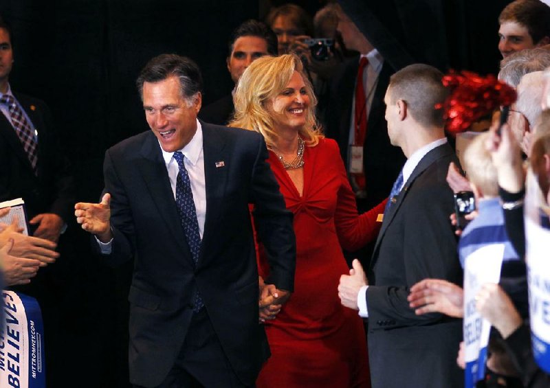 Mitt Romney and his wife, Ann, arrive at his election watch party Tuesday evening in Novi, Mich., after Romney was declared the victor in Michigan’s GOP presidential primary. 
