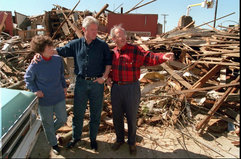 President Clinton, escorted by Arkansas State Rep. Percy Malone, talks to Judy Sligh  in downtown Arkadelphia. Sligh's store was leveled by the tornado that ripped through most of the state on March 1, 1997.