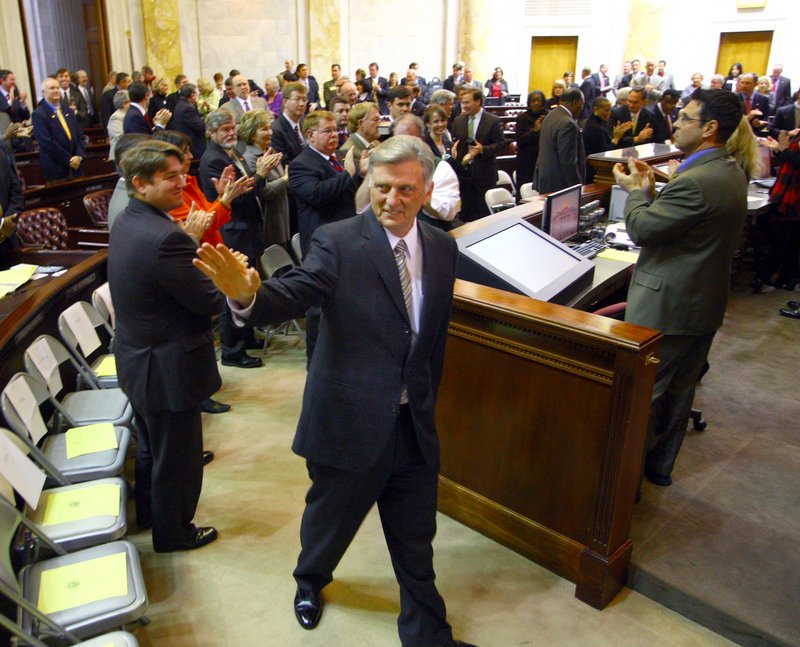 Gov. Mike Beebe greets legislators as he enters the house chamber at the start of the fiscal session Feb. 13. The session drew to a close Friday, March 2.