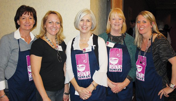 Dee Lea, from left, Kellie Rollins, Lynn Donald Carver, Jana Mayfield and Michelle Wynn, Soup Sunday volunteers, welcome guests to the 11th annual fundraiser for Arkansas Advocates for Children and Families on Feb. 26 at the Northwest Arkansas Convention Center in Springdale.
