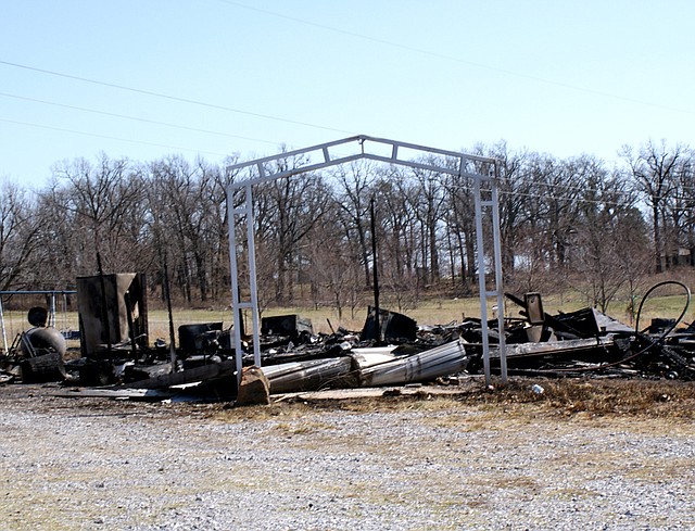 Support columns for a carport are all that remain standing following a fire that destroyed a frame home at Beaty Road last Thursday shortly after noon. The blaze, which is still under investigation by the sheriff's department, was prevented from spreading to nearby homes by three fire departments.