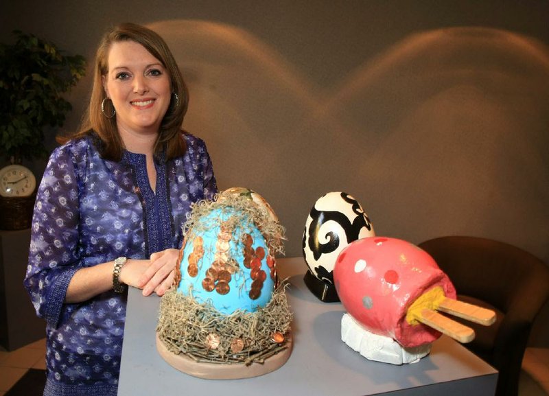 Lauren Landers shows off some of the colorful, creative eggs that will be on the auction block at this year’s Eggshibition event, a fundraiser for Youth Home. 