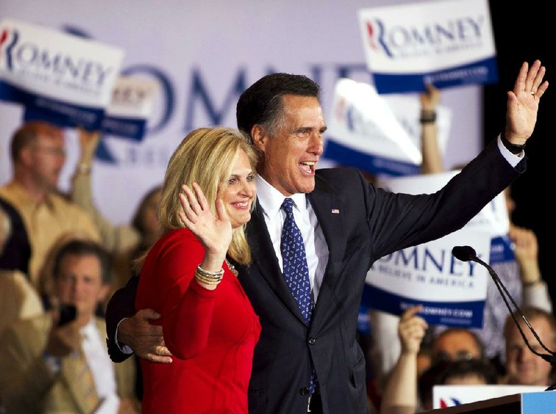 Former Massachusetts Gov. Mitt Romney and his wife, Ann, greet a crowd Tuesday in Schaumburg, Ill., after Romney won the state’s Republican presidential primary. 