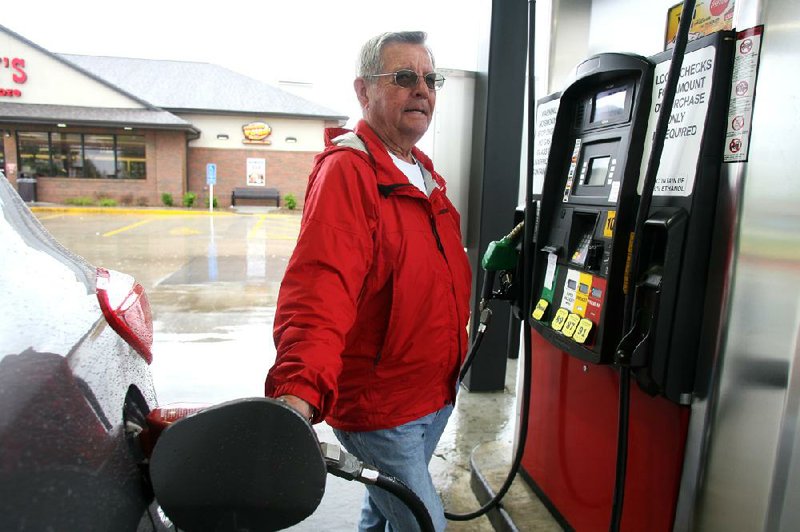 Arkansas Democrat-Gazette/RYAN MCGEENEY --03-22-2012-- Bill Bailey of Springdale fills the gas tank of a car from the dealership owned by he and his wife Thursday afternoon at the Casey's General Store at the intersection of Don Tyson Parkway and Old Missouri Road in Springdale. Bailey, who said he has lived in the area for 70 years, said this was the highest he could recall seeing gas prices in Northwest Arkansas, although he had recently paid as much as $4.35/gal. while visiting Sacramento, Calif.