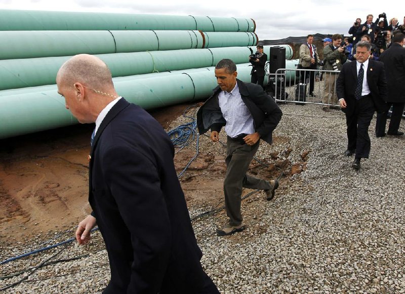 President Barack Obama arrives for an appearance Thursday at a pipe yard outside Cushing, Okla., where the southern segment of the Keystone pipeline will begin. 