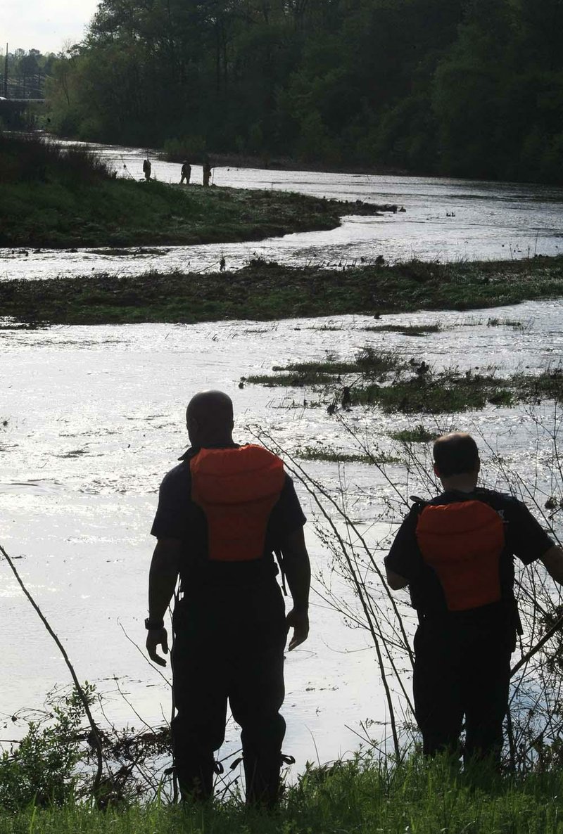 Little Rock Fire Department personnel search for a woman’s body Thursday morning that was spotted in high water at Boyle Park on Wednesday night. The high water also prevented emergency workers from recovering the body Wednesday and they were unable to find it Thursday. 